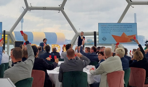 Deelnemers tijdens een lezing houdt kaartjes in de lucht