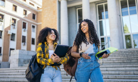 two female students walking with books